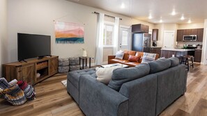 Movie night magic! Cozy up on the couches, grab your popcorn, and enjoy movie nights in this inviting living room.