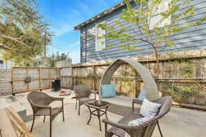 Private patio with a charming patio seating. We also include a gas grill and a cornhole set!