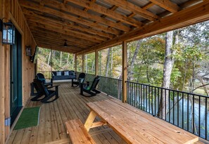 Outdoor seating to enjoy a meal with a view of the Cartecay River