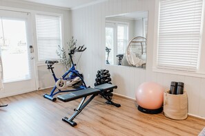 Fitness station featuring cardio, yoga mats and free weights