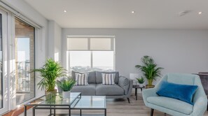 The living room gives access to the balcony which provides a city view