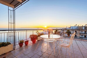 Enjoy Breathtaking Sunsets over the Sea with a Glass of Wine at the Outdoor Dinning Table