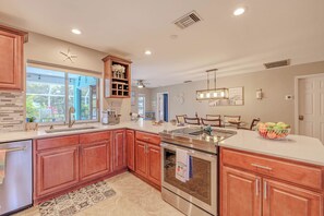 - Perfect blend of elegance & functionality in this beautifully designed kitchen
- Whip up your favorite meals with top of the line stainless steel appliances & extra counter space
- Wood cabinetry & stylish backsplash create an inviting atmosphere