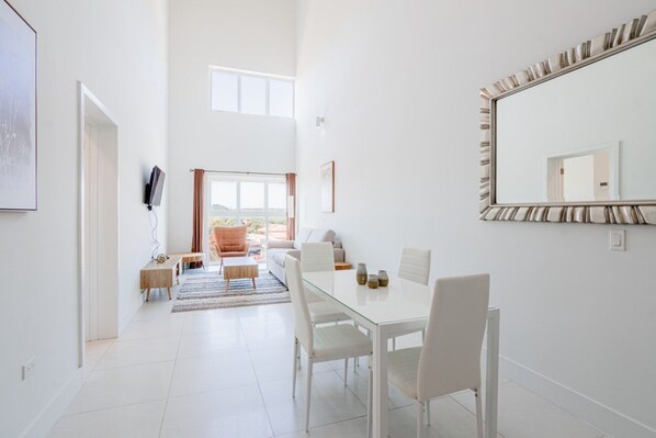 Step into this stunning space with soaring ceilings and sun-filled windows - Gather around the elegant dining area or unwind in the cozy lounge with vibrant views - Perfect setting for making memories, whether you’re dining, relaxing, or connecting