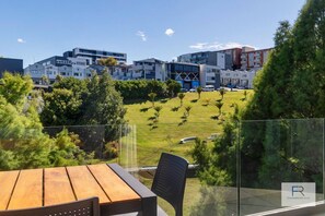 Sunny deck overlooking the park with outdoor dining