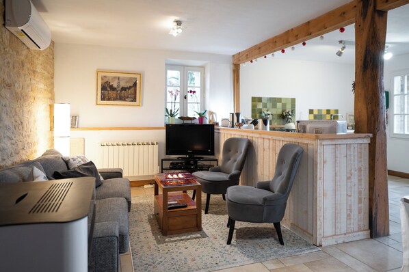 The open-plan living and dining space combining modern with rustic.