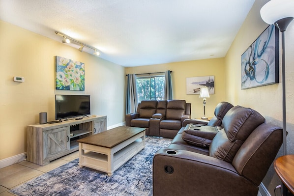 Comfortable living room with reclining couches- perfect for relaxing after a long day