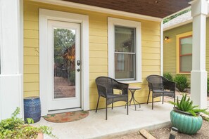 The front porch has overhead lighting and two seats to enjoy during your stay