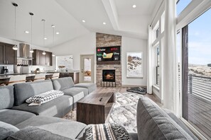 The living room boasts abundant natural light, a welcoming fireplace, and direct access to the deck.