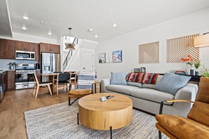 The open-concept living space, complete with a dining area, facilitates effortless conversation with family and friends.