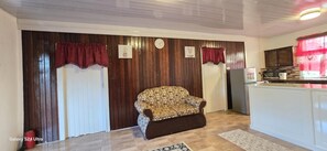 living room area with kitchen in the background. 