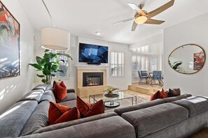 2nd living room with electric fireplace, smart TV, and lounge area.