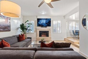 2nd living room with electric fireplace, smart TV, and lounge area.