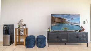 TV, hassocks, and water dispenser.