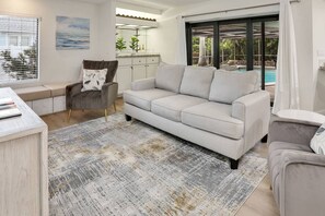 This spacious home includes two separate living rooms each with a flat screen TV and lanai access.