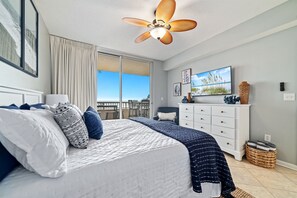 Primary room with king size bed and balcony access