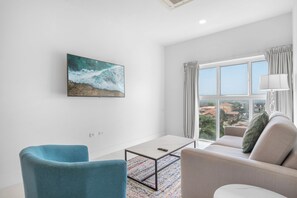 Cozy living room featuring a plush sectional sofa and calming natural light - Welcoming space perfect for relaxing with a book, streaming your favorite shows, or enjoying the view - Designed for comfort and simplicity, it's your ideal retreat