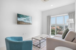 Cozy living room featuring a plush sectional sofa and calming natural light - Welcoming space perfect for relaxing with a book, streaming your favorite shows, or enjoying the view - Designed for comfort and simplicity, it's your ideal retreat