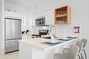 Step into this stylish, modern kitchen and let your culinary creativity flow - Featuring top-notch stainless steel appliances and a bright, inviting design - From morning coffee to gourmet dinners, this kitchen is your happy place for cooking
