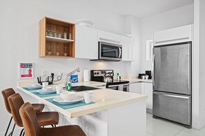Cook and connect in this modern kitchen with all the tools you need for your meals - Sleek, open design makes preparing food and staying involved with the group effortless - A functional and stylish space to inspire your culinary adventures