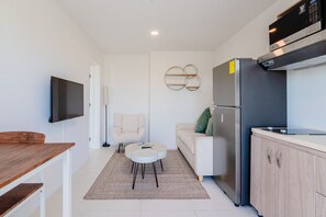 Unwind in a bright living area with stylish decor and cozy furnishings - Open plan layout offers a perfect spot for relaxing, dining, or watching your favorite shows - Thoughtful design, this space feels warm and welcoming for your stay