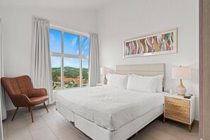 The bedroom with a king size bed and lots of natural light coming in