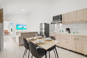 Savor your meals in this cozy dining space with sleek modern furniture and an intimate atmosphere - Equipped with a coffee maker and fridge for convenient dining options - Perfect for planning your Aruba adventures