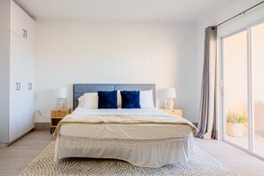 Bedroom features a king size bed, sliding doors to the private patio