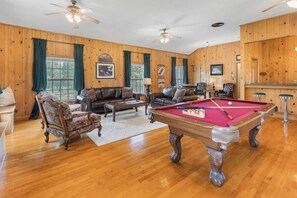 Really cool game room with pool table, sitting area, large screen tv and bar seating