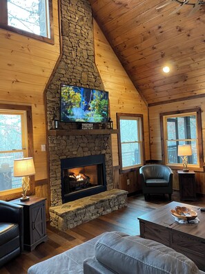 main level great room with sectional couch and chairs, great for reading or TV!