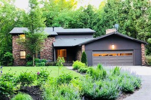 This updated custom California Contemporary home on the Black River was built in 1972