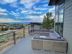Plenty of outdoor furniture on the deck that overlooks the lake