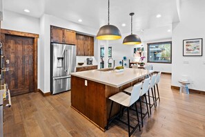 Kitchen: Drip coffee maker, Crockpot, blender, cooking utensils, tableware, toaster oven, main floor