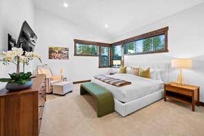 Master bedroom: King bed, Smart TV, suede rocking chair, ottoman, heated floors, heated towel rack, upper floor
