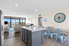 Bright kitchen and dining combo, perfect for savoring meals and stunning views. 