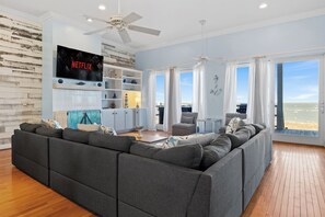 Cozy seating, ocean views, and a smart TV—perfect for relaxing together.
