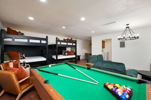 Sleep, play, repeat! Our bunk room with a pool table guarantees endless fun for guests of all ages.