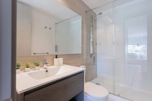 Experience luxury in this modern bathroom with a sleek shower and elegant design, perfect for relaxation.
