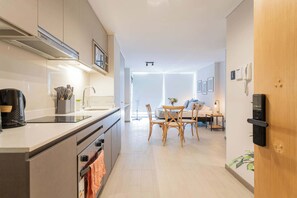 Experience modern living with this chic kitchen and dining area, perfect for cozy meals and gatherings.