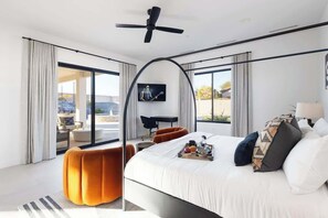 Master bedroom with backyard patio door. Desk and work area. Smart TV with cable provided.