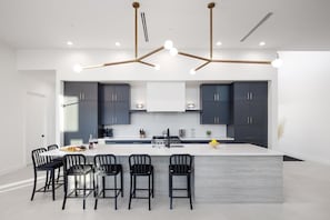 Fully loaded kitchen with built in fridge/freezer, dishwasher, microwave and large kitchen island. Oven/stove range with gas burners. Coffee station with Kerurig and 10 cup capabilities, coffee provided. 
