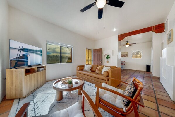 Living room with plenty of cozy, comfortable seating and smart TV