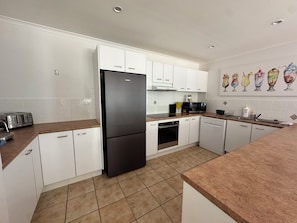 Fully stocked kitchen, fridge, dish washer, microwave, oven, stove