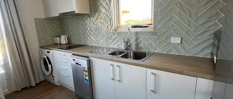 The modern kitchen is fully equipped with everything you'll need for your stay.