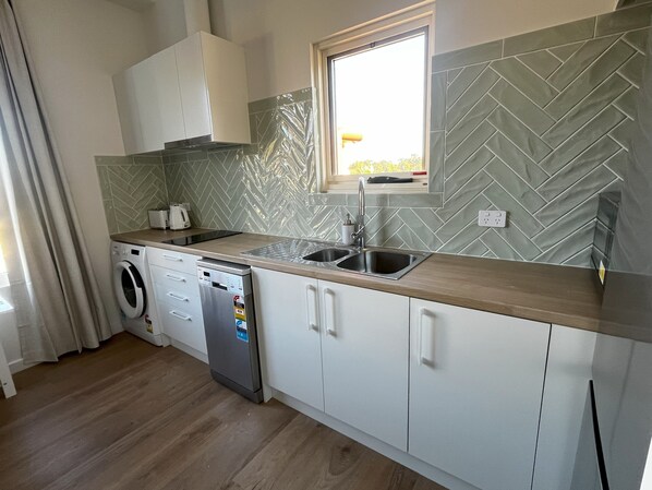 The modern kitchen is fully equipped with everything you'll need for your stay.