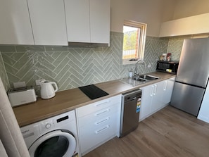 The modern kitchen is fully equipped with everything you'll need for your stay.