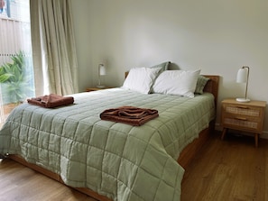 Generous and comfortable queen bedroom, leading to the outside courtyard space.