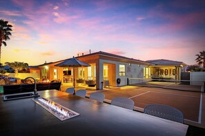 Elegant and modern curb appeal with warm lighting, clean architecture, and beautifully landscaped entry.