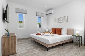 Enjoy ultimate comfort in this spacious bedroom, complete with a cozy bed and flat-screen TV for the perfect retreat.