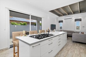 Cook up your favorite meals in this fully equipped kitchen, designed for both style and convenience.